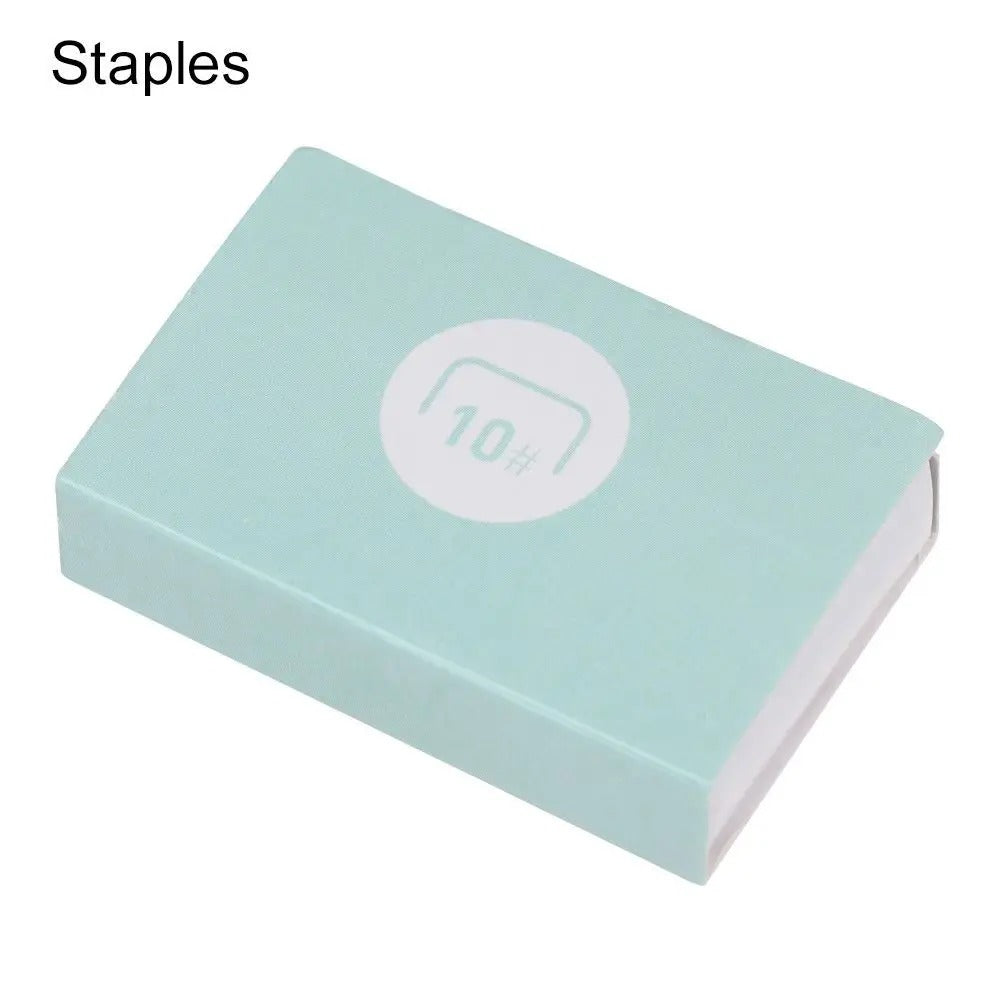 A mint green box of staples on a white background, with the word 'Staples' in black text in the top-left corner and a white circular '1000' stamp graphic on the top of the box.